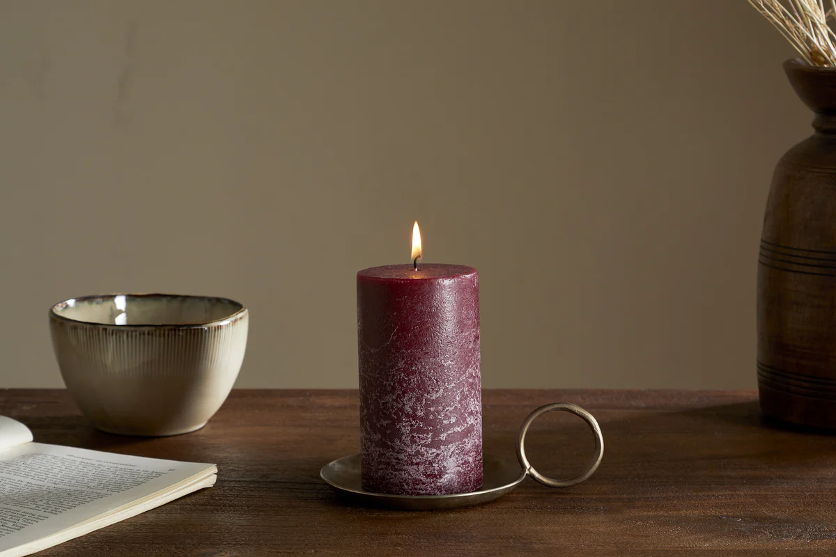 dark cherry coloured candle flickering