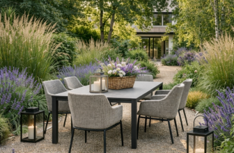 Garden seating area with sofa, chairs, wooden table, and flowering plants