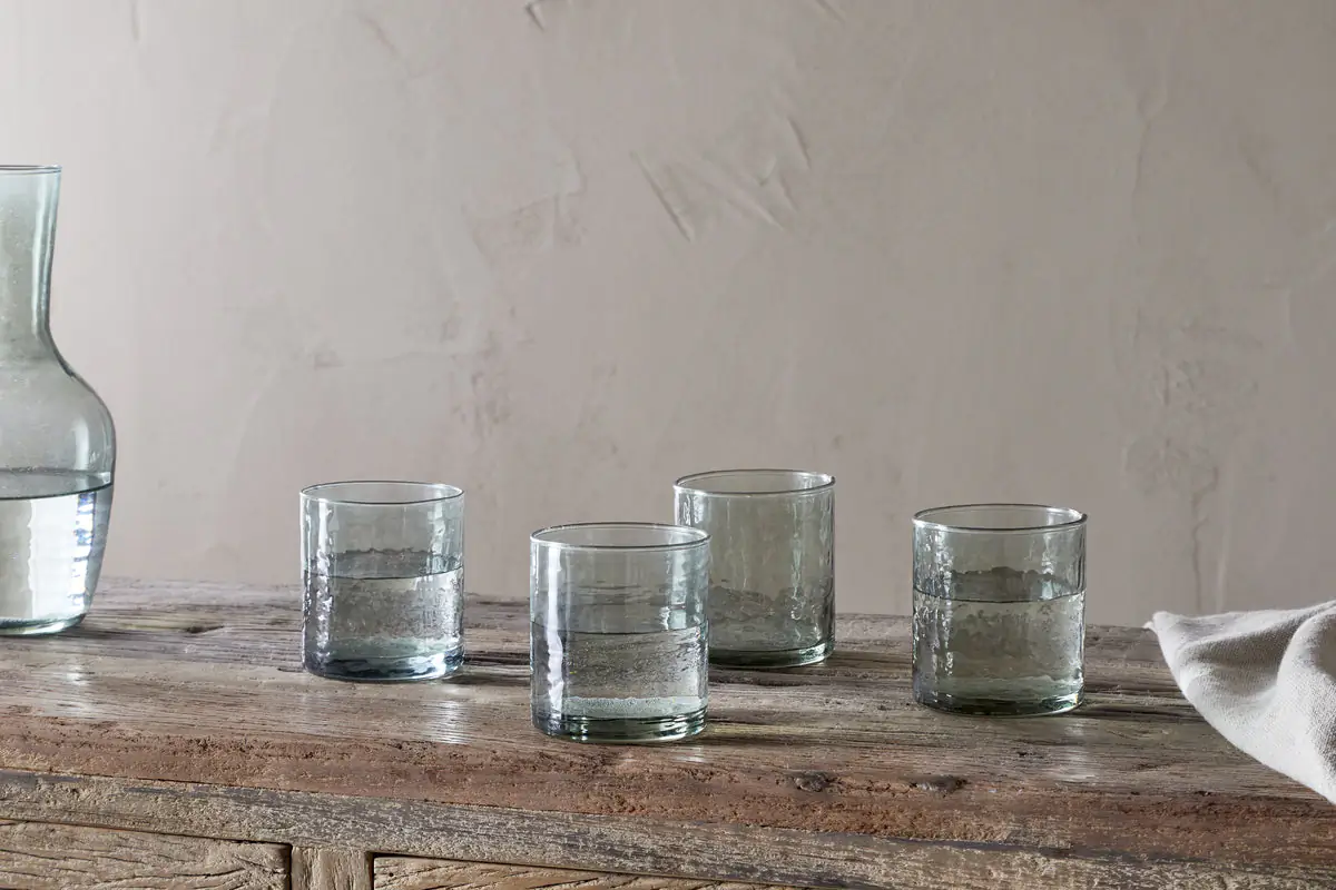The Honest Nkuku Recycled Glassware Review: We Look At 10 Tumblers, Highballs and Gin Glasses four recycled glass hammered tumblers in sage green