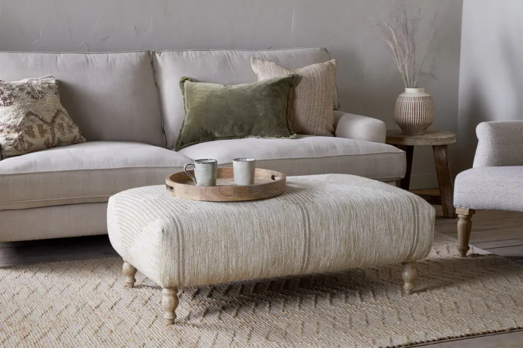 Aranya upholstered footstool in natural by Nkuku