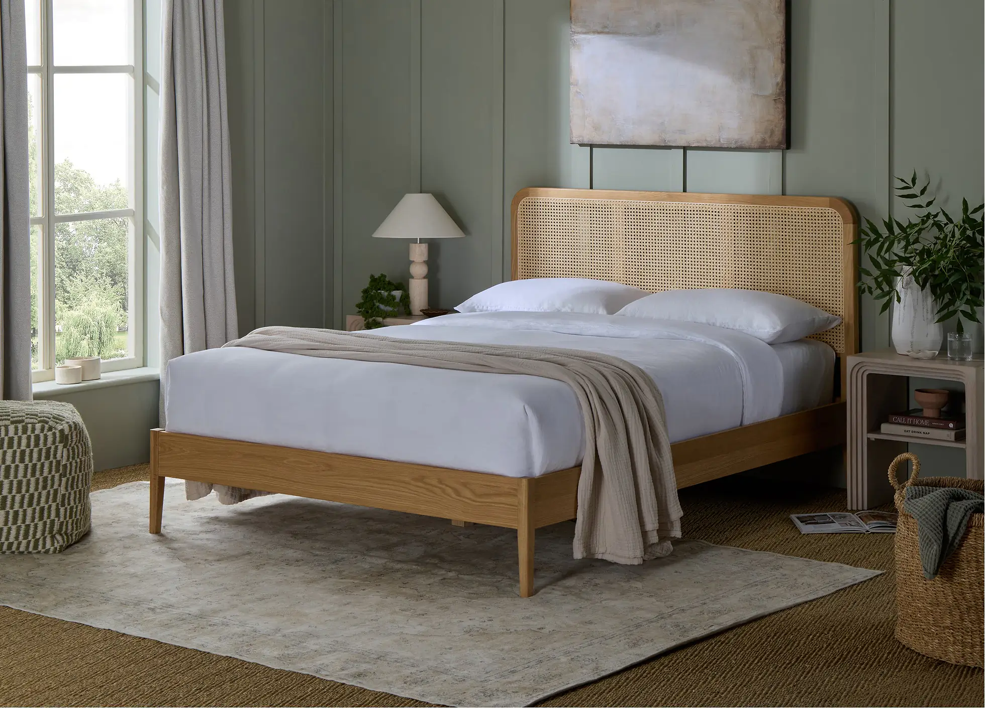 How to Create a Sustainable Bedroom: A Practical Guide Fernley Wooden Bed from Simba Sleep with a rattan headboard in a sage green calming bedroom.