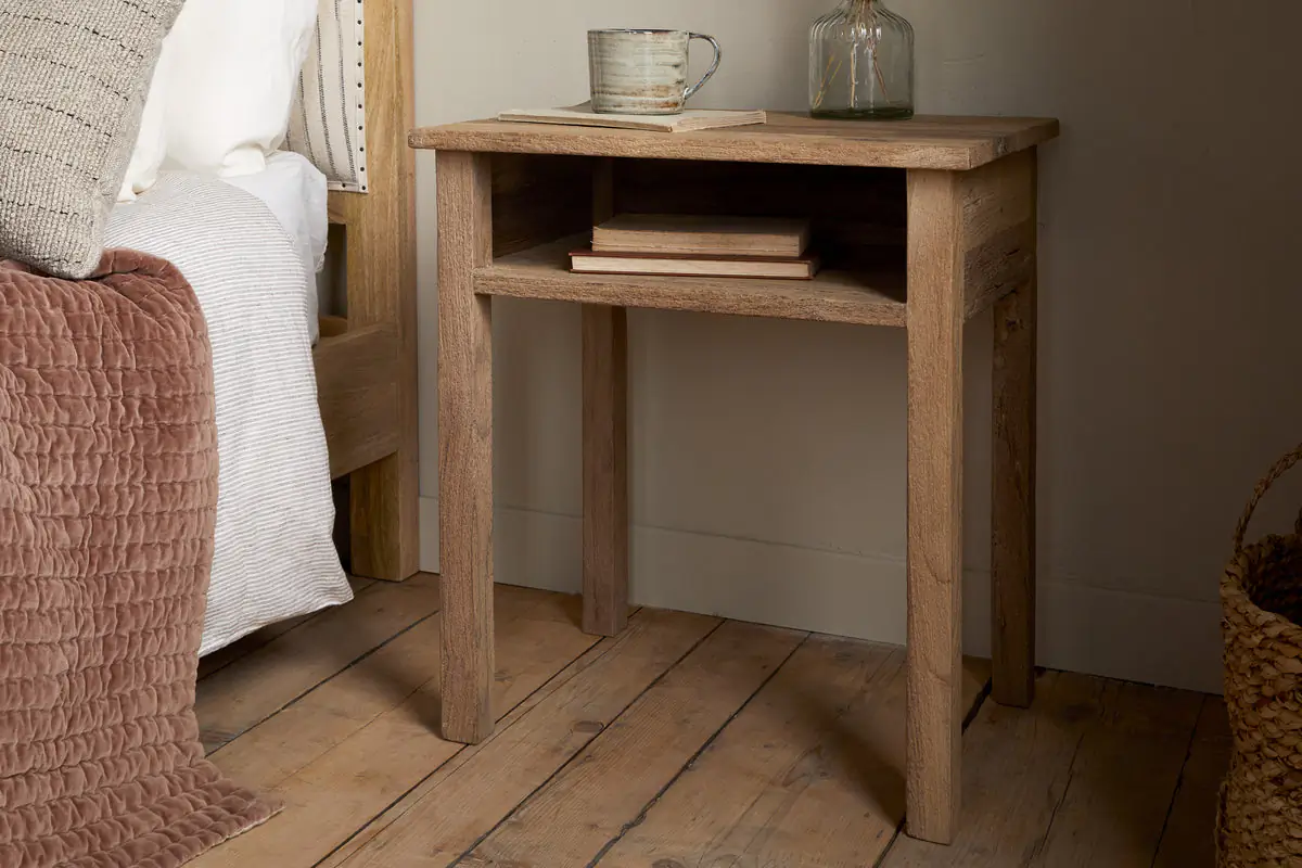How to Create a Sustainable Bedroom: A Practical Guide The Iya Reclaimed Wood Bedside Table in Natural styled beside a bed.