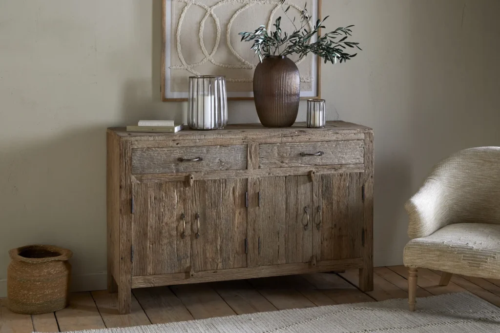 Reclaimed wood sideboard with home decor items on top of it