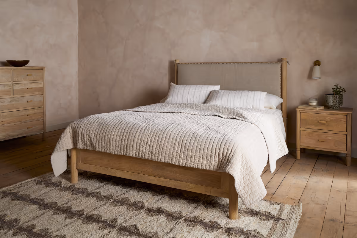 How to Create a Sustainable Bedroom: A Practical Guide Sri mango wood bed in a natural upholstered headboard colour by Nkuku