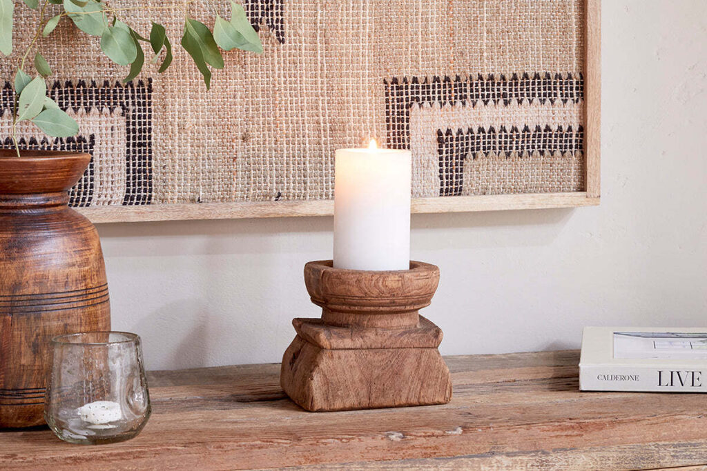 Reclaimed wood candlestick holder with candle.
