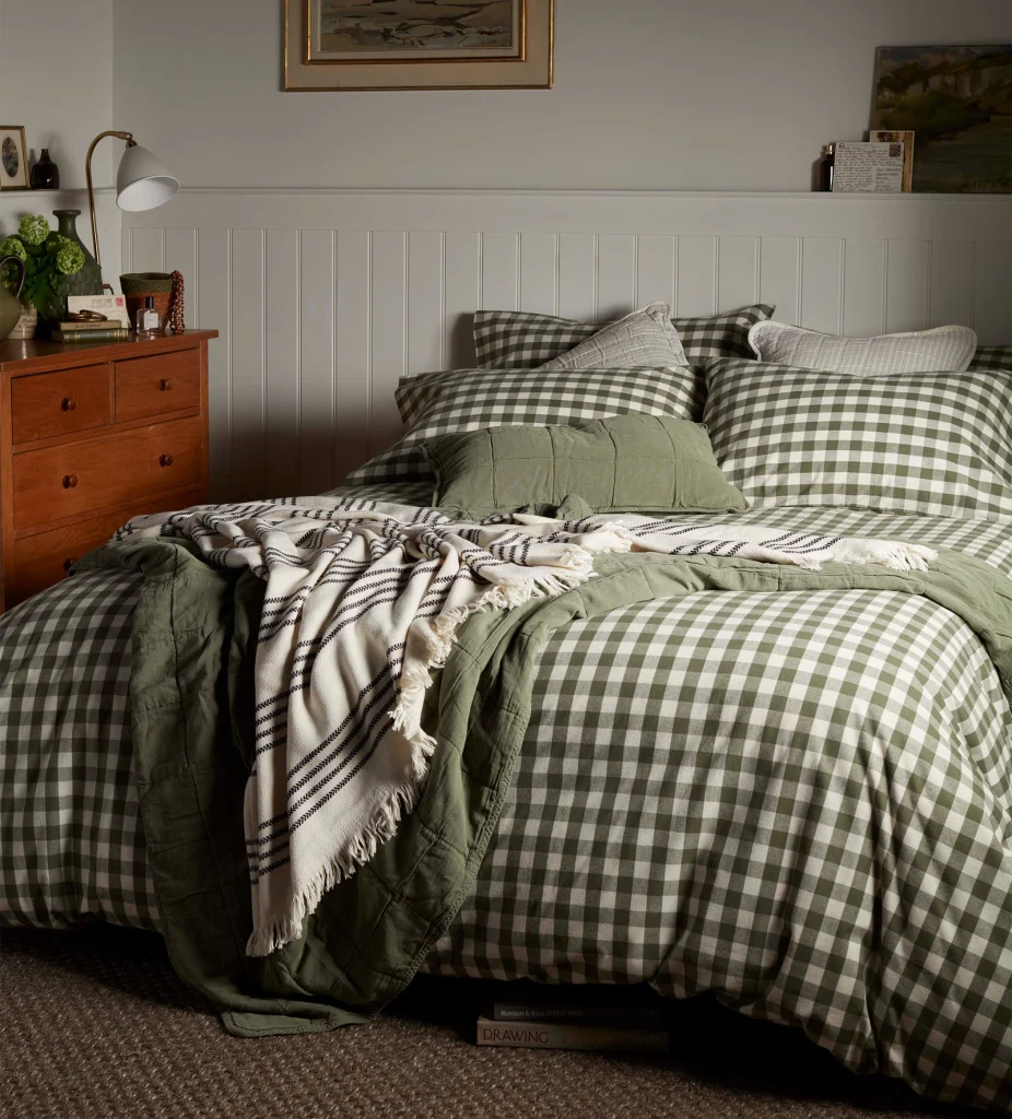 Autumn Winter Home Trends 2026: A Sustainable Edit Olive gingham bedding and duvet set in a light bedroom with panelling.