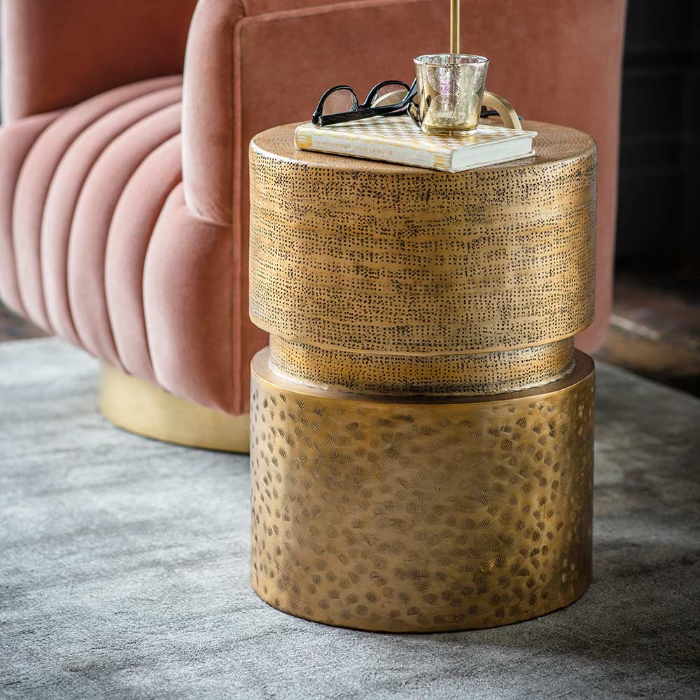Brass round side table in hammered apttern by Atkin and thyme.
