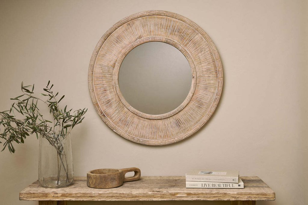 Mango wood carved mirror in circular shape by nkuku.