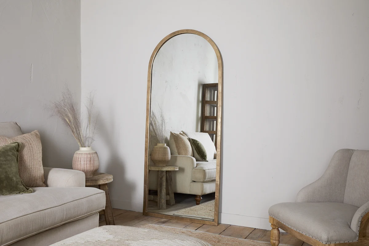 Antique brass full length mirror with curved frame by Nkuku.