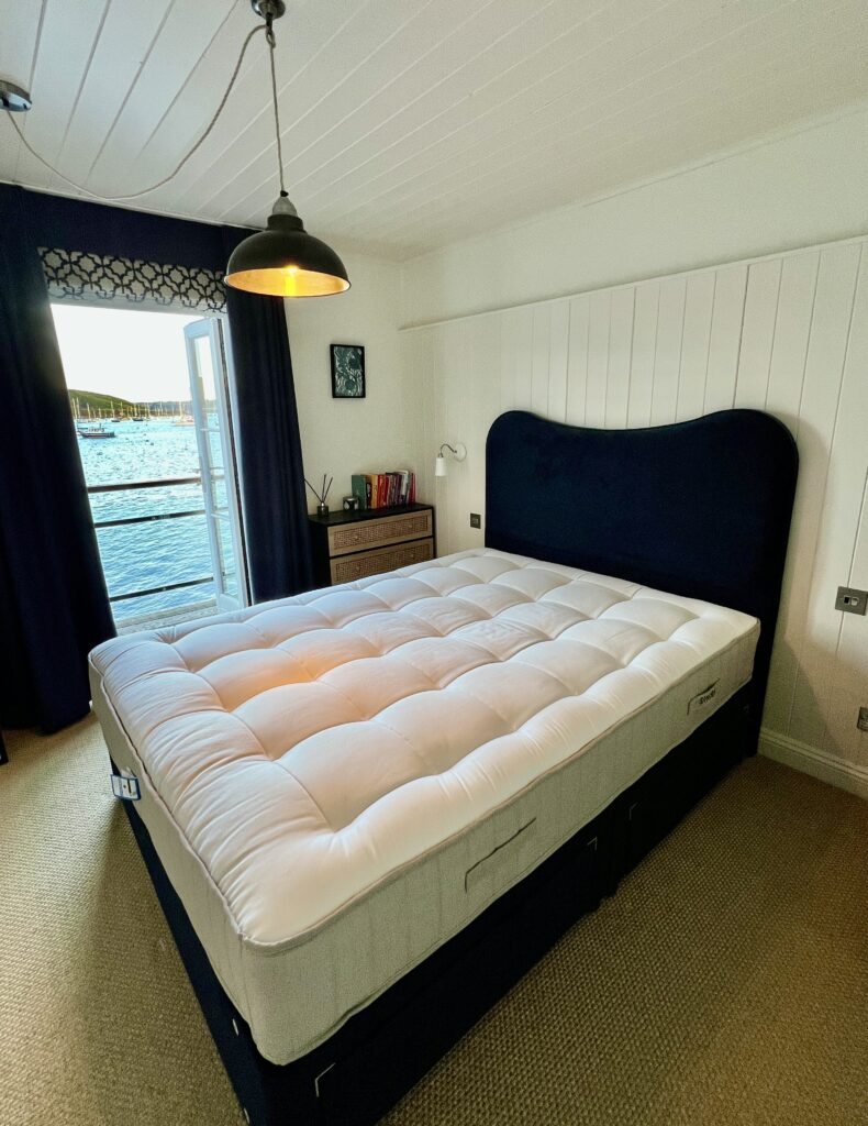 I Slept on the Simba Natural Hybrid Source Mattress for a Month: Here's My Honest Review Simba Natural Hybrid Source Review on mattress shown in a bedroom beside the sea.