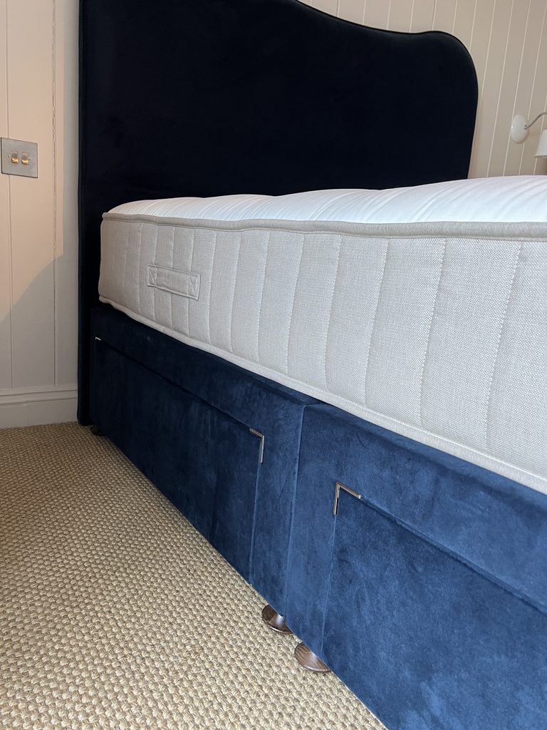 I Slept on the Simba Natural Hybrid Source Mattress for a Month: Here's My Honest Review Close up of Simba Natural Hybrid Source Mattress with Jesmond Bed frame in navy velvet.