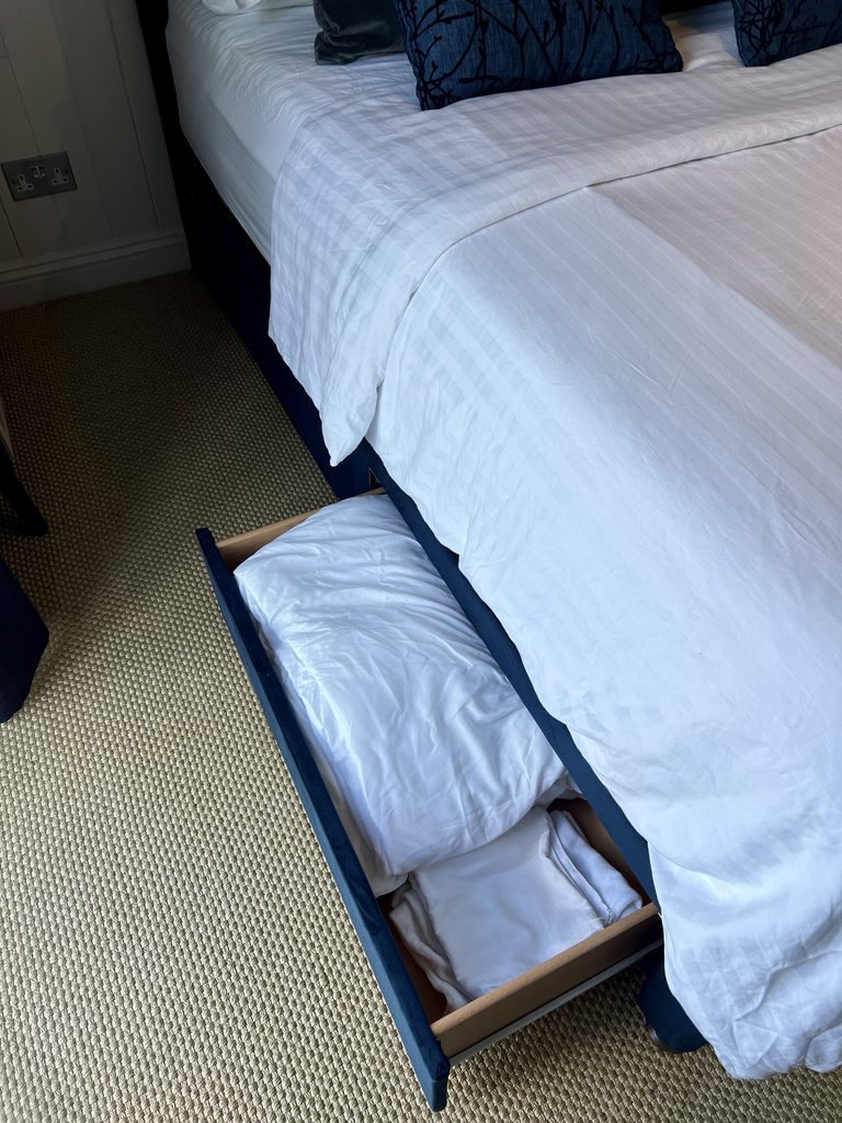 Storage draw open of Simba Sleep navy velvet Jesmond bed.