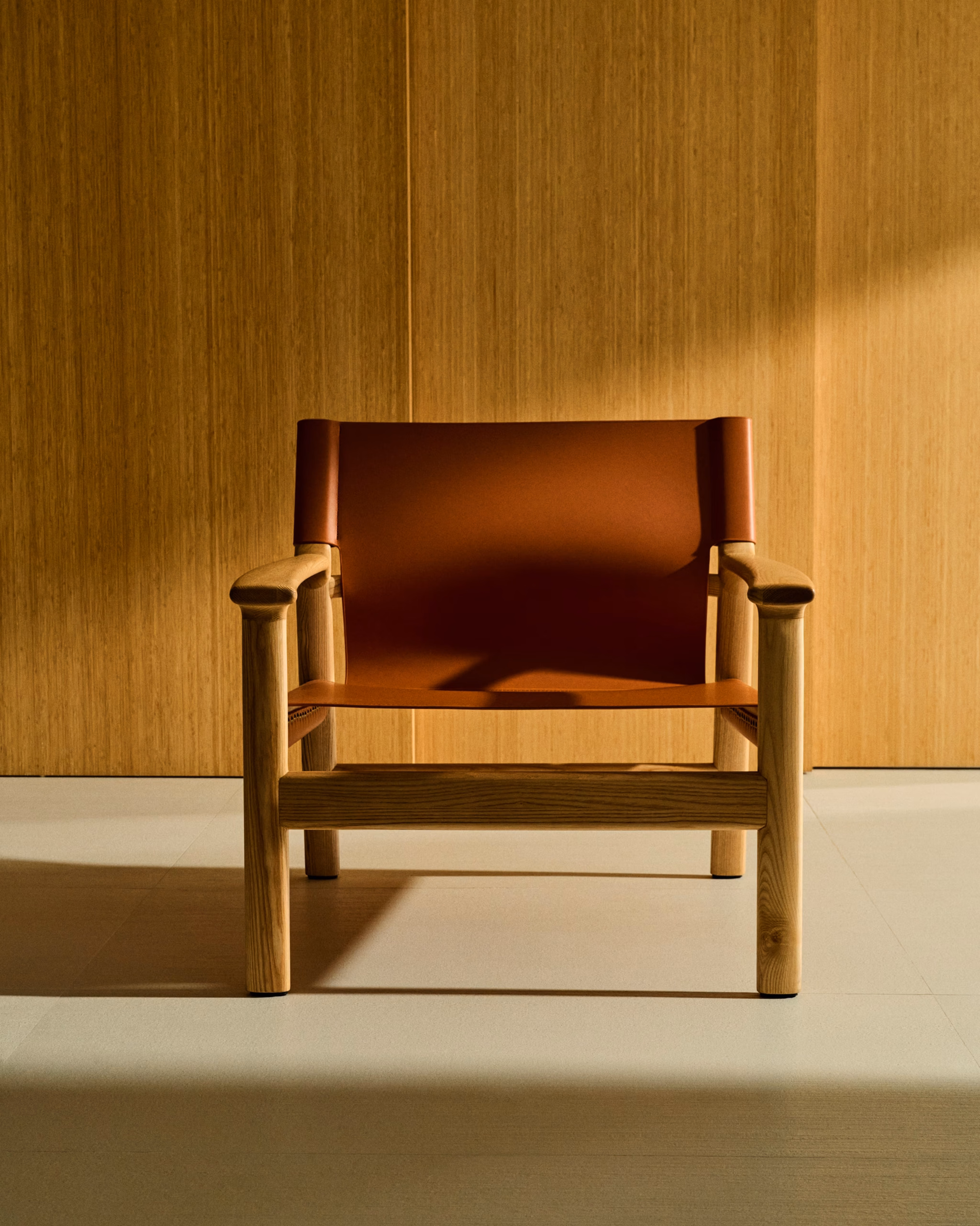 Autumn Winter Home Trends 2026: A Sustainable Edit Tan leather armchair with natural oak frame.