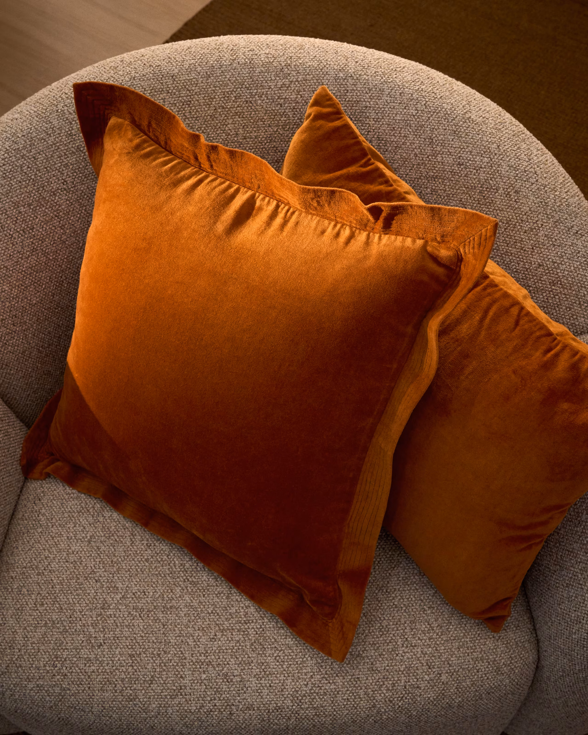 Autumn Winter Home Trends 2026: A Sustainable Edit Orange velvet cushion with edging