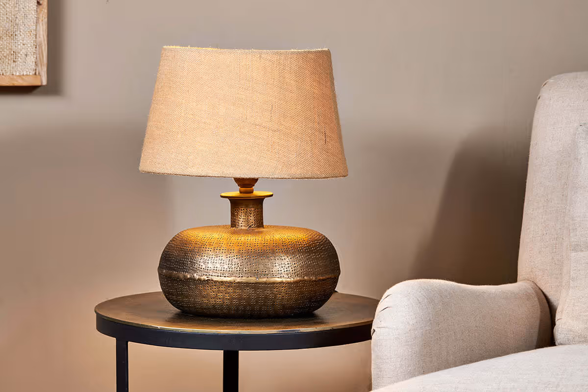 Autumn Winter Home Trends 2026: A Sustainable Edit Brass lamp with natural beige woven linen lampshade.
