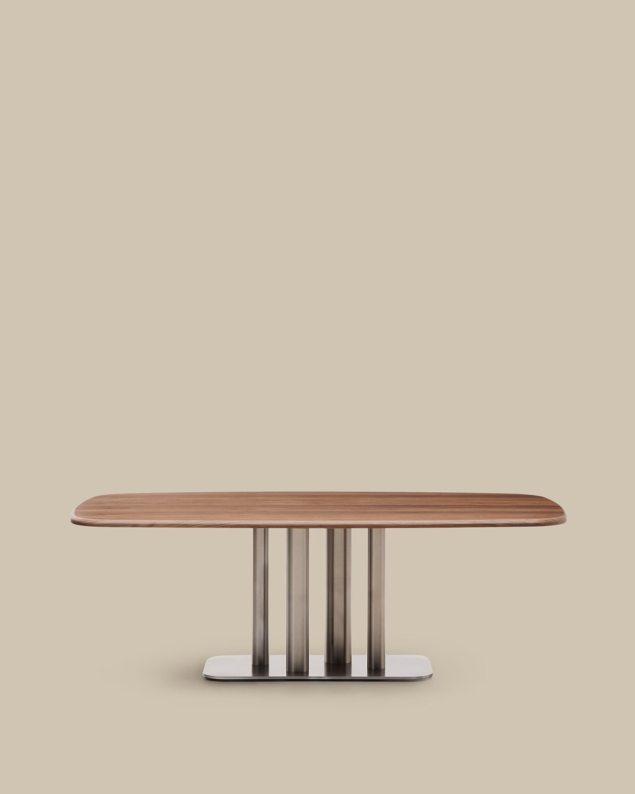 Autumn Winter Home Trends 2026: A Sustainable Edit Dining table made from walnut veneer and legs with brushed stainless steel base.