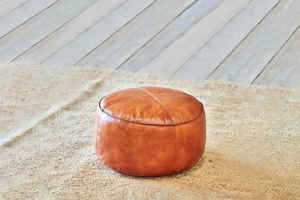 Autumn Winter Home Trends 2026: A Sustainable Edit Leather pouf in aged tan colour.