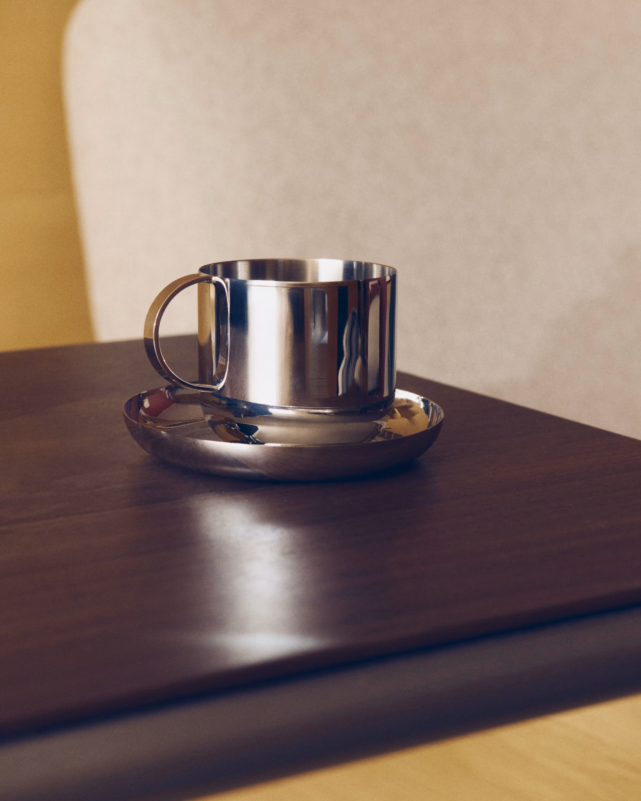 Autumn Winter Home Trends 2026: A Sustainable Edit Stainless steel cup on walnut countertop.