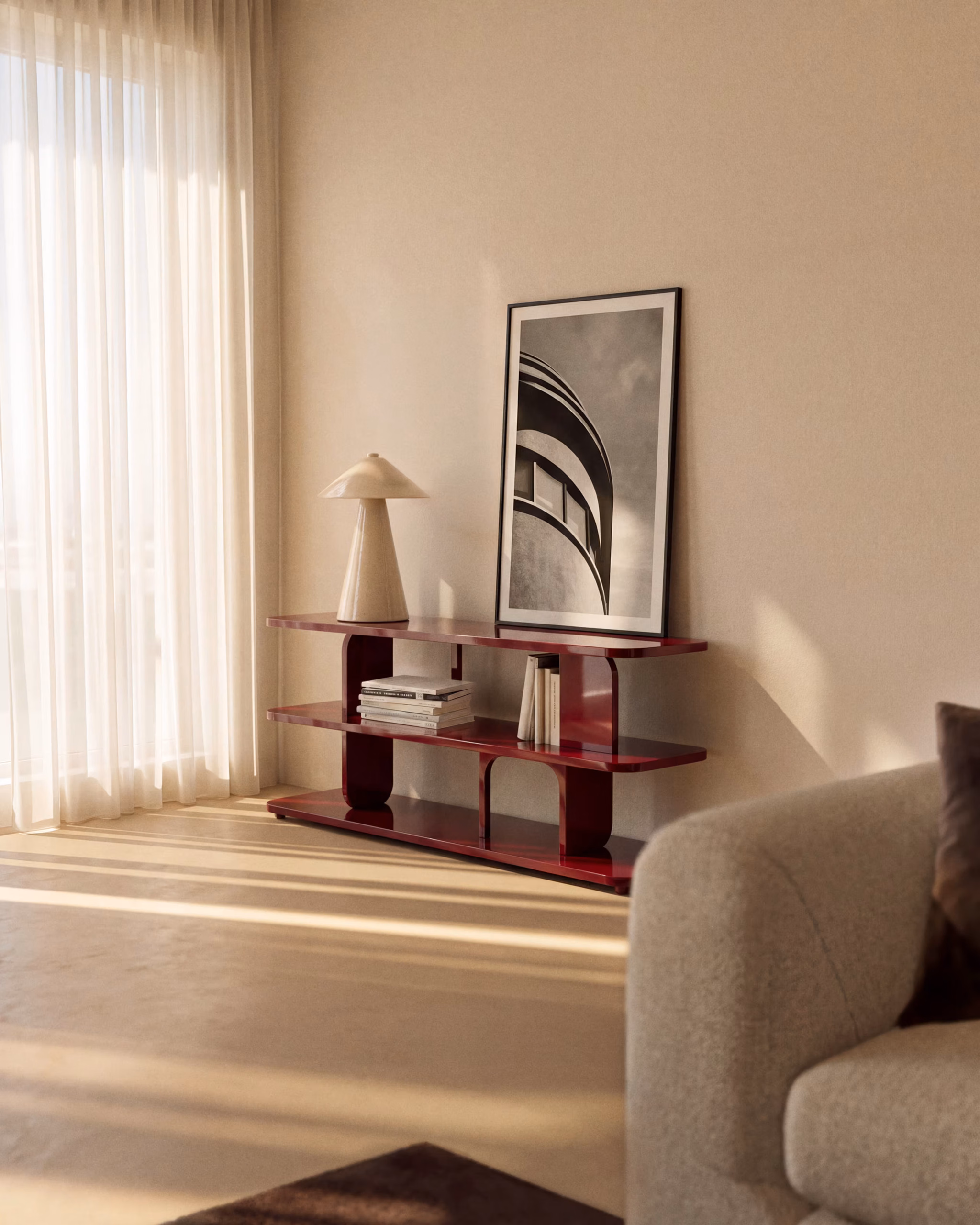 Autumn Winter Home Trends 2026: A Sustainable Edit Burgundy glossy MDF shelving unit in a living room with a beige lamp on top and artwork in white and black.
