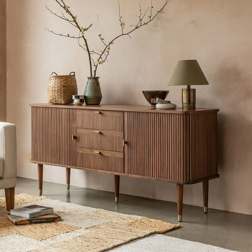 Autumn Winter Home Trends 2026: A Sustainable Edit Sideboard in walnut with brass handles and a mid century modern style.