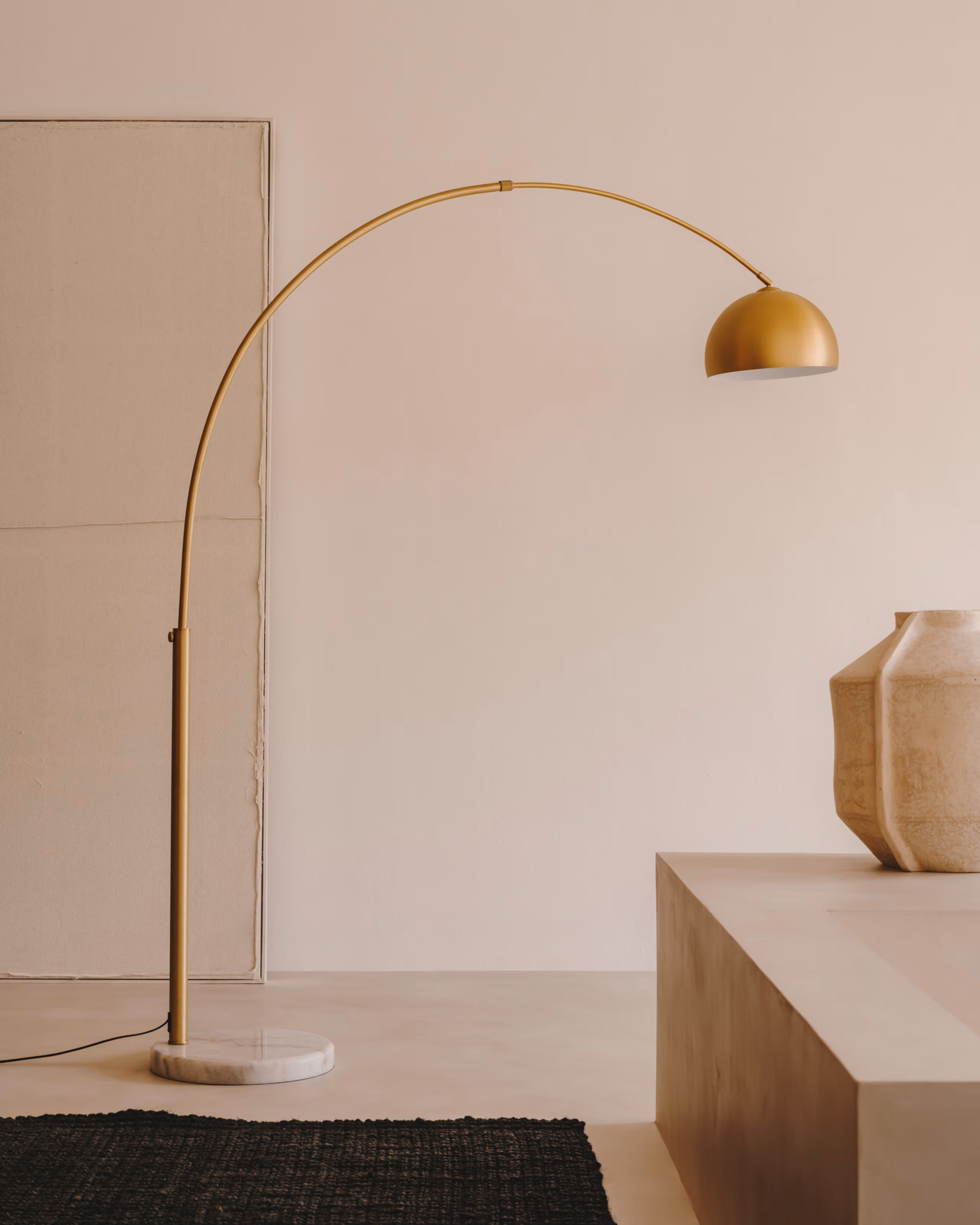 Autumn Winter Home Trends 2026: A Sustainable Edit Brass metal floor lamp with curved top with marble floor stand.